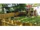 A charming fenced backyard featuring a deck with outdoor seating and a lush lawn for relaxation at 1425 Parkmont Dr, Roswell, GA 30076