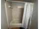 Bathroom with neutral tile and a tub, complemented by a modern shower curtain at 1425 Parkmont Dr, Roswell, GA 30076