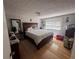 Cozy bedroom features hardwood floors, a large window, and a comfortable king-size bed at 1425 Parkmont Dr, Roswell, GA 30076