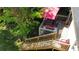 Aerial view of a wooden deck with dining area, grill, and lush backyard greenery at 1425 Parkmont Dr, Roswell, GA 30076