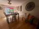 Inviting dining room with dark wood table and chairs, sliding door to backyard, and large decorative clock at 1425 Parkmont Dr, Roswell, GA 30076