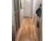 Hallway with hardwood floors and neutral walls; adjacent to built-in storage and white doors at 1425 Parkmont Dr, Roswell, GA 30076