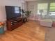 Cozy living room features hardwood floors, sectional sofa, entertainment center, and exercise equipment at 1425 Parkmont Dr, Roswell, GA 30076