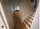 Staircase with wooden steps and white trim, alongside a hallway with hardwood floors at 1425 Parkmont Dr, Roswell, GA 30076