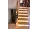 Staircase with hardwood steps and white risers, adjacent to bathroom, and wood handrail at 1425 Parkmont Dr, Roswell, GA 30076