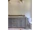 Gray vanity with double sinks, stone countertop, and a contemporary toilet with gold fixtures at 2461 Fernleaf Nw Ct, Atlanta, GA 30318