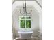 Bathroom with a vaulted ceiling, soaking tub, double vanity and a view to the backyard at 2461 Fernleaf Nw Ct, Atlanta, GA 30318