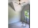 Bedroom featuring vaulted ceilings, ceiling fan, backyard view, and natural lighting at 2461 Fernleaf Nw Ct, Atlanta, GA 30318
