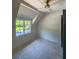 Bedroom with neutral walls, ceiling fan, and large window with backyard views at 2461 Fernleaf Nw Ct, Atlanta, GA 30318