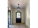 Beautiful foyer with black door and lantern-style light fixture at 2461 Fernleaf Nw Ct, Atlanta, GA 30318
