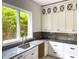 Modern kitchen with a large window, under-cabinet lighting and dark backsplash at 2461 Fernleaf Nw Ct, Atlanta, GA 30318