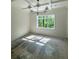 Bright living room with modern chandelier and large window offering backyard views at 2461 Fernleaf Nw Ct, Atlanta, GA 30318