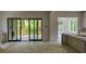 Open living space with sliding glass doors to a deck and view to a chandelier lit room at 2461 Fernleaf Nw Ct, Atlanta, GA 30318