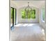 Light filled sunroom featuring three large windows offering abundant views of nature at 2461 Fernleaf Nw Ct, Atlanta, GA 30318