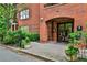 Brick building entrance with an arched entryway and brick-paved walkway with greenery at 273 12Th Ne St # 313, Atlanta, GA 30309