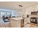 Open kitchen with white cabinets, modern appliances, and a large island with a breakfast bar at 273 12Th Ne St # 313, Atlanta, GA 30309