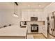 Modern kitchen featuring stainless steel appliances, white cabinets, and a breakfast bar at 273 12Th Ne St # 313, Atlanta, GA 30309