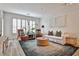 Bright living room featuring plantation shutters, natural light, and sleek, modern furnishings at 273 12Th Ne St # 313, Atlanta, GA 30309