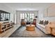 Bright living room with a TV, modern furnishings, and plantation shutters at 273 12Th Ne St # 313, Atlanta, GA 30309