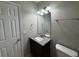 Bathroom featuring granite countertop, dark wood vanity and a medicine cabinet at 3472 Riverview Chase Way, Ellenwood, GA 30294