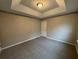 Bedroom with a modern tray ceiling, neutral colored walls and new carpet at 3472 Riverview Chase Way, Ellenwood, GA 30294
