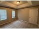 Bedroom featuring a tray ceiling, neutral walls and carpet at 3472 Riverview Chase Way, Ellenwood, GA 30294