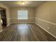 Dining room featuring hardwood floors, neutral paint, and a large window for ample natural light at 3472 Riverview Chase Way, Ellenwood, GA 30294