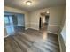 Dining room featuring hardwood floors, neutral paint, and open access to the kitchen and living areas at 3472 Riverview Chase Way, Ellenwood, GA 30294