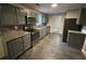 Updated kitchen with stainless steel appliances, granite countertops, and dark cabinets, ready for cooking at 3472 Riverview Chase Way, Ellenwood, GA 30294