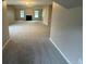 Large, carpeted living room with abundant natural light at 3472 Riverview Chase Way, Ellenwood, GA 30294