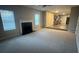 Open-concept living room with fireplace leading into an adjacent kitchen at 3472 Riverview Chase Way, Ellenwood, GA 30294