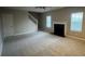 Spacious living room with carpet, a fireplace, and staircase access to upper floors at 3472 Riverview Chase Way, Ellenwood, GA 30294