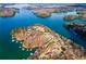 Majestic aerial view of a lake neighborhood featuring waterfront properties and docks at 6337 Ansel Ct, Buford, GA 30518