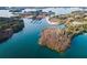 Stunning aerial perspective of a lake inlet with several boat slips and undeveloped islands at 6337 Ansel Ct, Buford, GA 30518