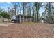 Backyard with screened-in porch, storage shed, and plenty of outdoor space at 6337 Ansel Ct, Buford, GA 30518