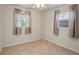 Bright bedroom with neutral walls, tile flooring, and natural light from two windows at 6337 Ansel Ct, Buford, GA 30518
