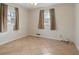 Spacious bedroom featuring neutral paint, tile flooring, and two windows at 6337 Ansel Ct, Buford, GA 30518