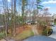 Exterior view of property showing driveway, landscaping, and proximity to the lake at 6337 Ansel Ct, Buford, GA 30518