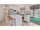 Bright kitchen featuring stainless steel appliances, tile floors, and an island with seating at 6337 Ansel Ct, Buford, GA 30518