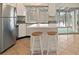 Bright kitchen features stainless steel refrigerator and center island with seating at 6337 Ansel Ct, Buford, GA 30518