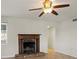 Bright living room featuring a ceiling fan and beautiful fireplace at 6337 Ansel Ct, Buford, GA 30518