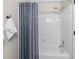 Full bath featuring a shower-tub with white tile and blue patterned shower curtain at 706 Twin Brooks Se Ct, Marietta, GA 30067