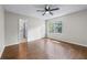 Bright bedroom with hardwood floors, fan, and view into the bathroom and backyard at 706 Twin Brooks Se Ct, Marietta, GA 30067