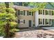 Charming two-story townhouse with tan siding, green shutters, and beautiful stone walkway at 706 Twin Brooks Se Ct, Marietta, GA 30067