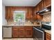 Classic kitchen featuring wooden cabinets, stainless steel appliances, and tile backsplash at 706 Twin Brooks Se Ct, Marietta, GA 30067