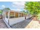 Enclosed back porch with white railings overlooks a brick patio and serene backyard at 1081 Singleton Valley Cir, Norcross, GA 30093