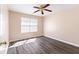 Sunlit bedroom with a ceiling fan, window, and wood-look floors at 1081 Singleton Valley Cir, Norcross, GA 30093