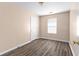 Bedroom with a window for natural light and wood-look flooring at 1081 Singleton Valley Cir, Norcross, GA 30093
