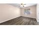A bright bedroom with a ceiling fan and window for natural light at 1081 Singleton Valley Cir, Norcross, GA 30093