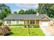 Charming ranch-style home with manicured lawn, white trim, and inviting curb appeal at 1081 Singleton Valley Cir, Norcross, GA 30093